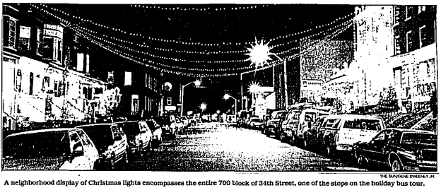 Black and white image from the Baltimore Sun of 34th Street in Hampden, with lights strung across the street.